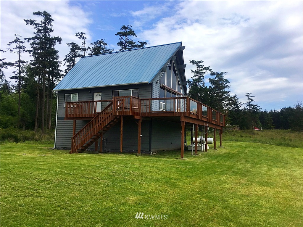 44 Beach Court Decatur Island, WA 98221 - Photo 9 of 25 a view of a house with a yard