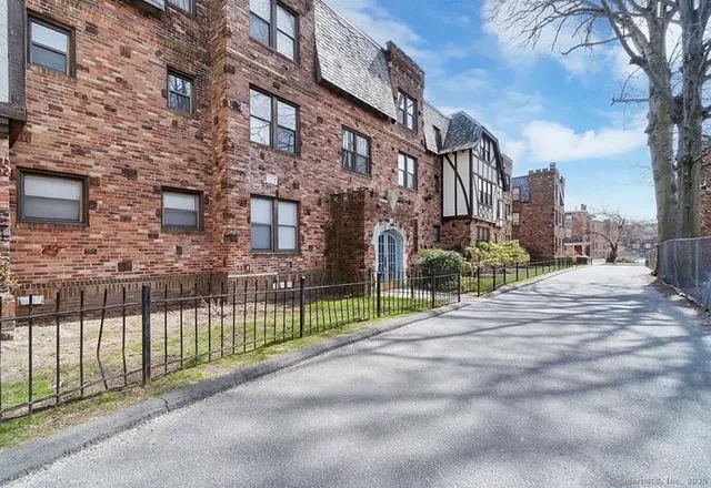 a view of a brick building next to a road