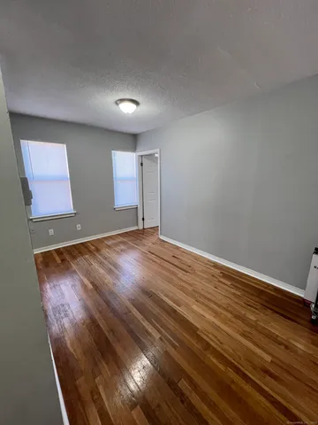 a view of room with wooden floor