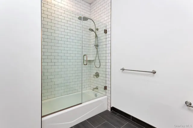 a bathroom with a bathtub and shower