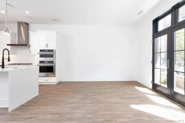 a view of a kitchen with a sink and a window