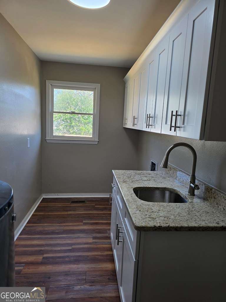 123 Preston Drive Fitzgerald, GA 31750 - Photo 12 of 24 a kitchen with granite countertop wood cabinets a sink and dishwasher