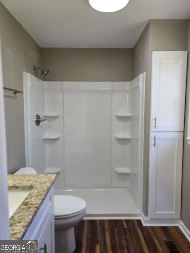123 Preston Drive Fitzgerald, GA 31750 - Photo 20 of 24 a bathroom with a granite countertop sink toilet and shower
