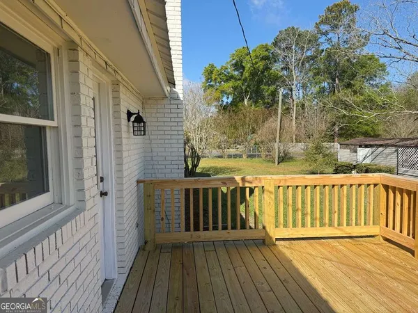 a view of deck with wooden floor and chair