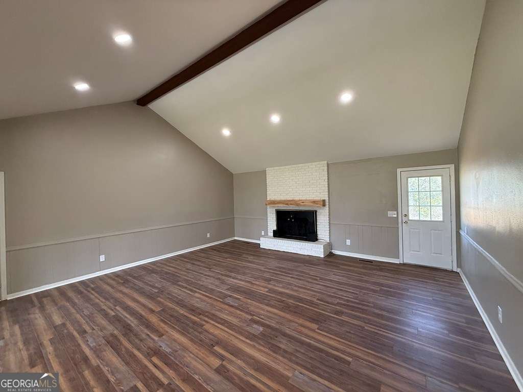 123 Preston Drive Fitzgerald, GA 31750 - Photo 4 of 24 a view of empty room with wooden floor and fireplace