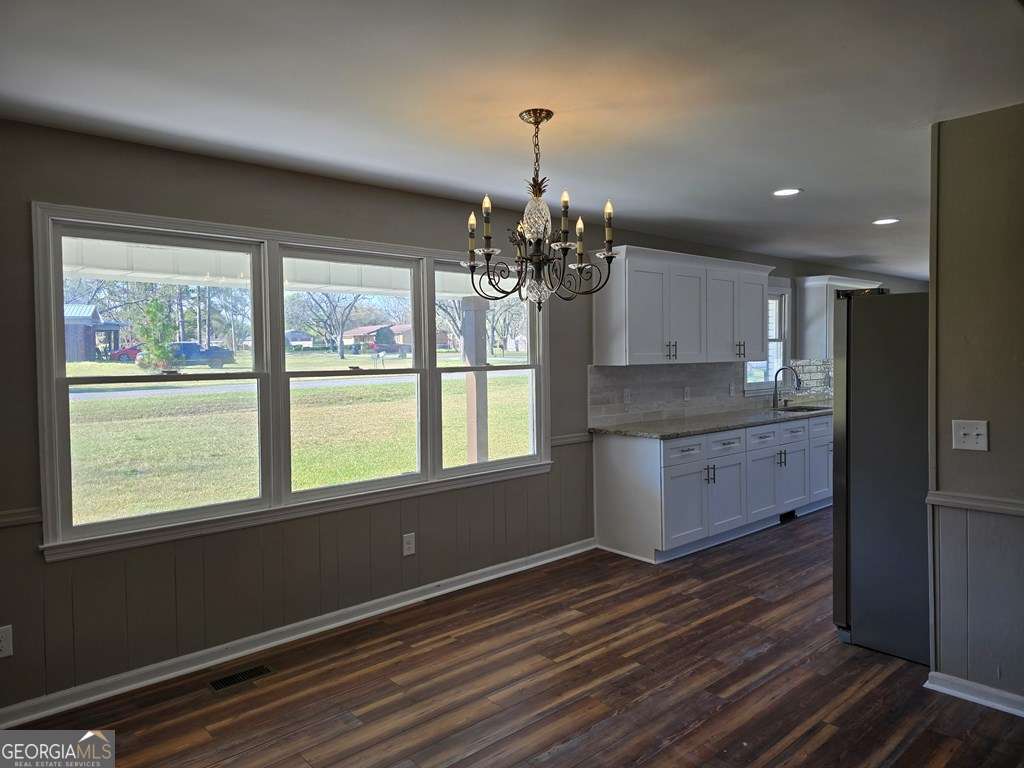 123 Preston Drive Fitzgerald, GA 31750 - Photo 5 of 24 a kitchen with a refrigerator and windows