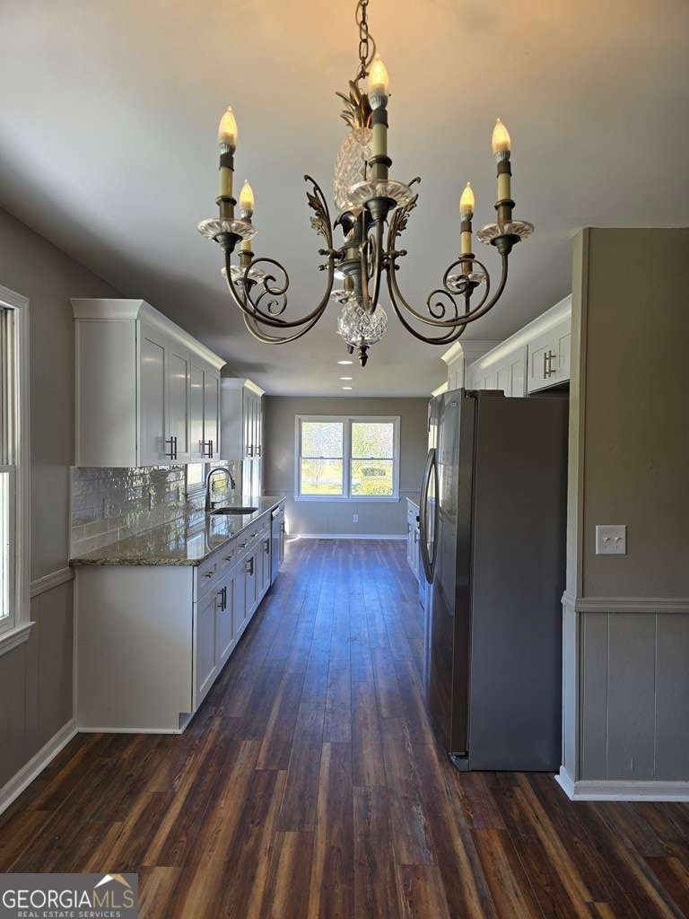 123 Preston Drive Fitzgerald, GA 31750 - Photo 6 of 24 a view of a kitchen with wooden floor and cabinets