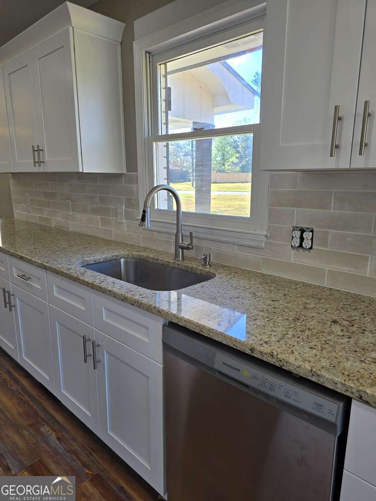 123 Preston Drive Fitzgerald, GA 31750 - Photo 9 of 24 a kitchen with granite countertop white cabinets and a window