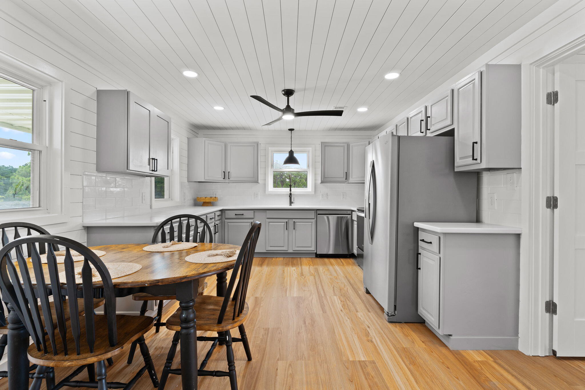 1357 Pearson Road Milton, FL 32583 - Photo 11 of 52 a kitchen with granite countertop a refrigerator a sink a stove a dining table and chairs