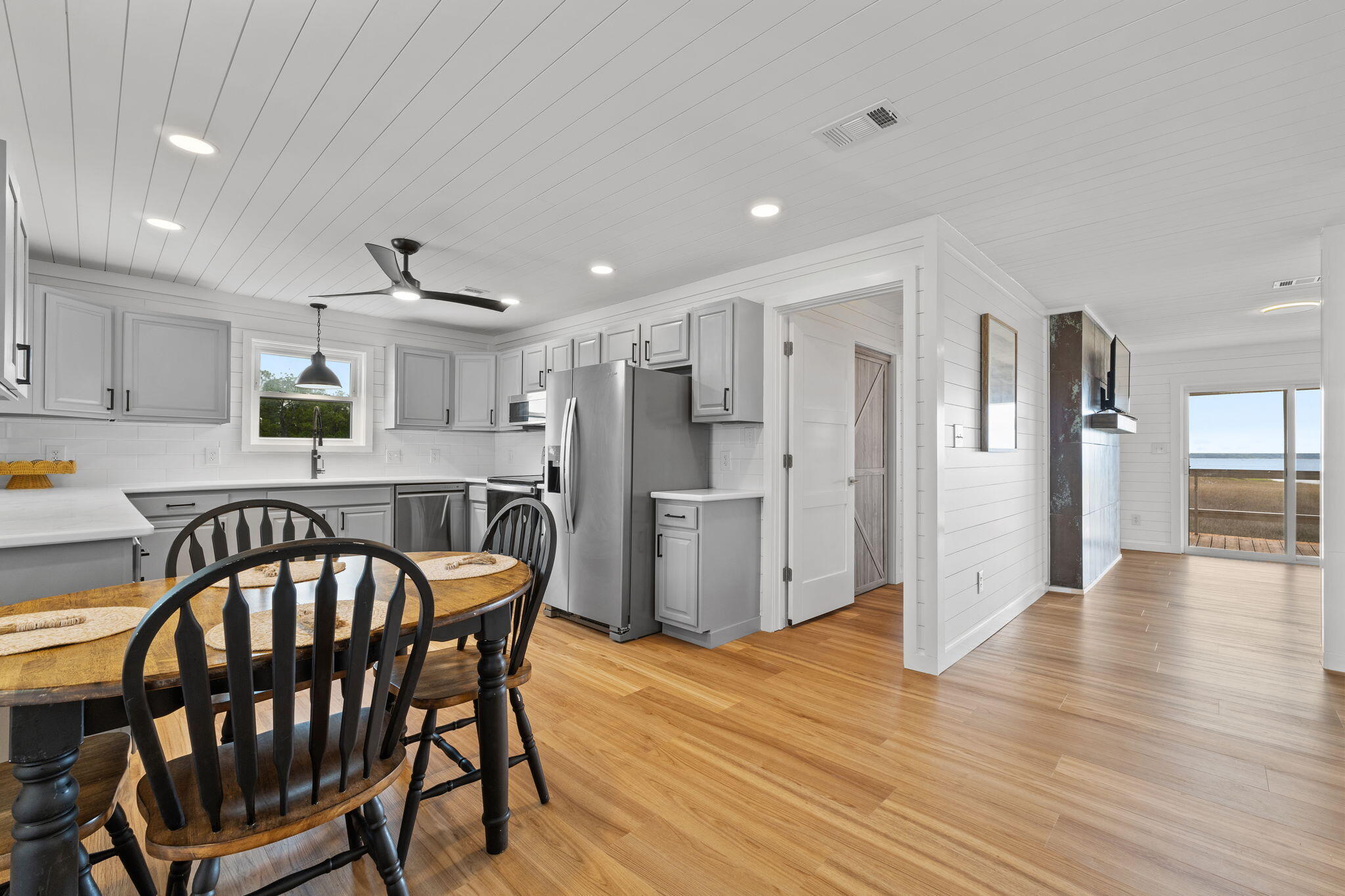 1357 Pearson Road Milton, FL 32583 - Photo 12 of 52 a kitchen with stainless steel appliances granite countertop a dining table chairs refrigerator and sink
