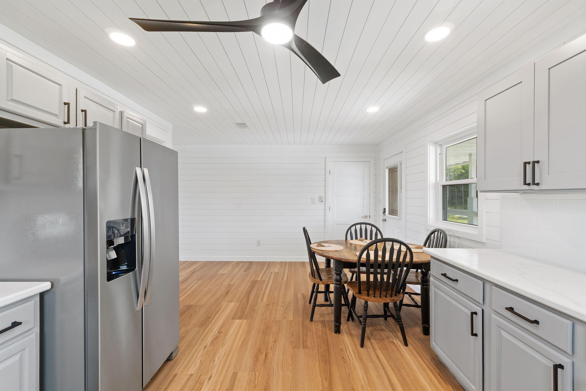 1357 Pearson Road Milton, FL 32583 - Photo 14 of 52 a kitchen with stainless steel appliances granite countertop dining table chairs and wooden floor