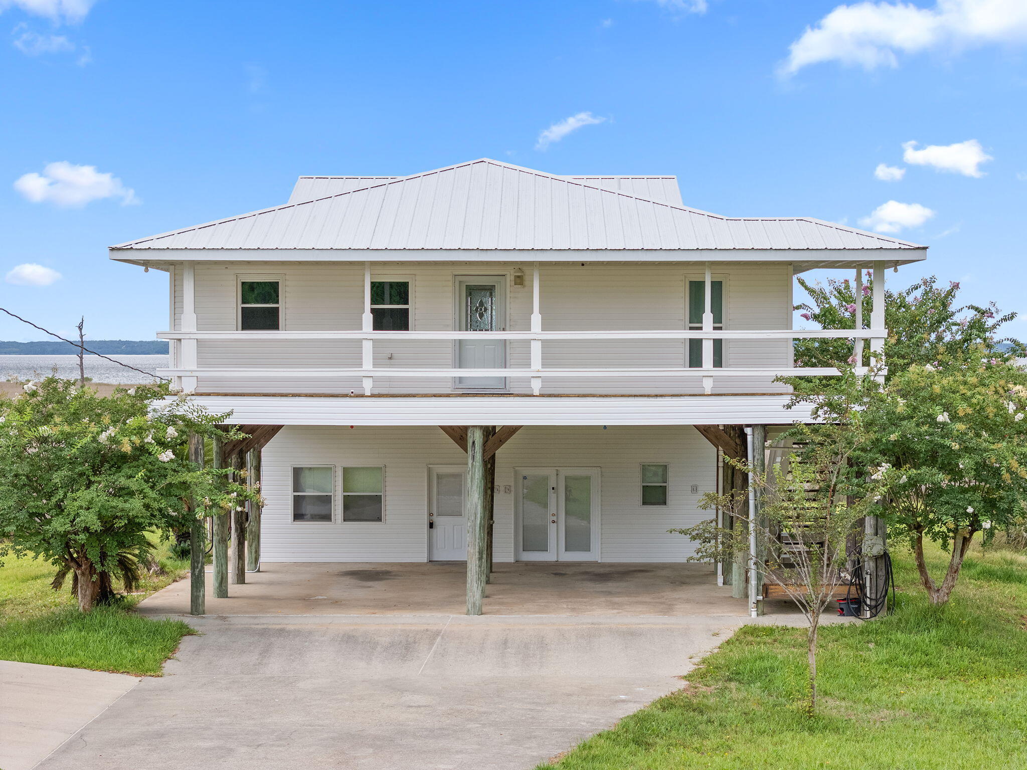 1357 Pearson Road Milton, FL 32583 - Photo 2 of 52 a front view of a house with a garden and plants