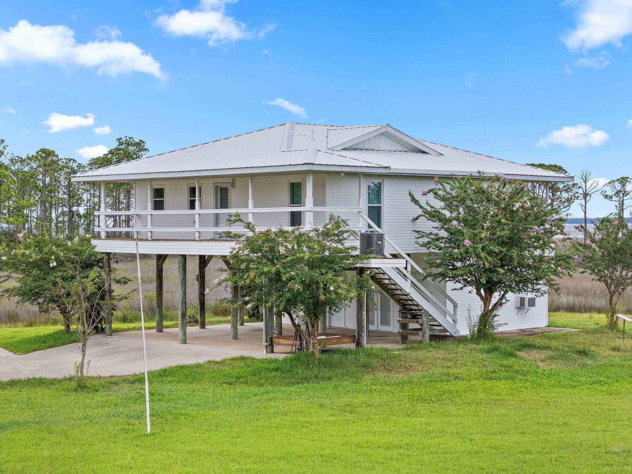 1357 Pearson Road Milton, FL 32583 - Photo 27 of 52 a front view of a house with a garden