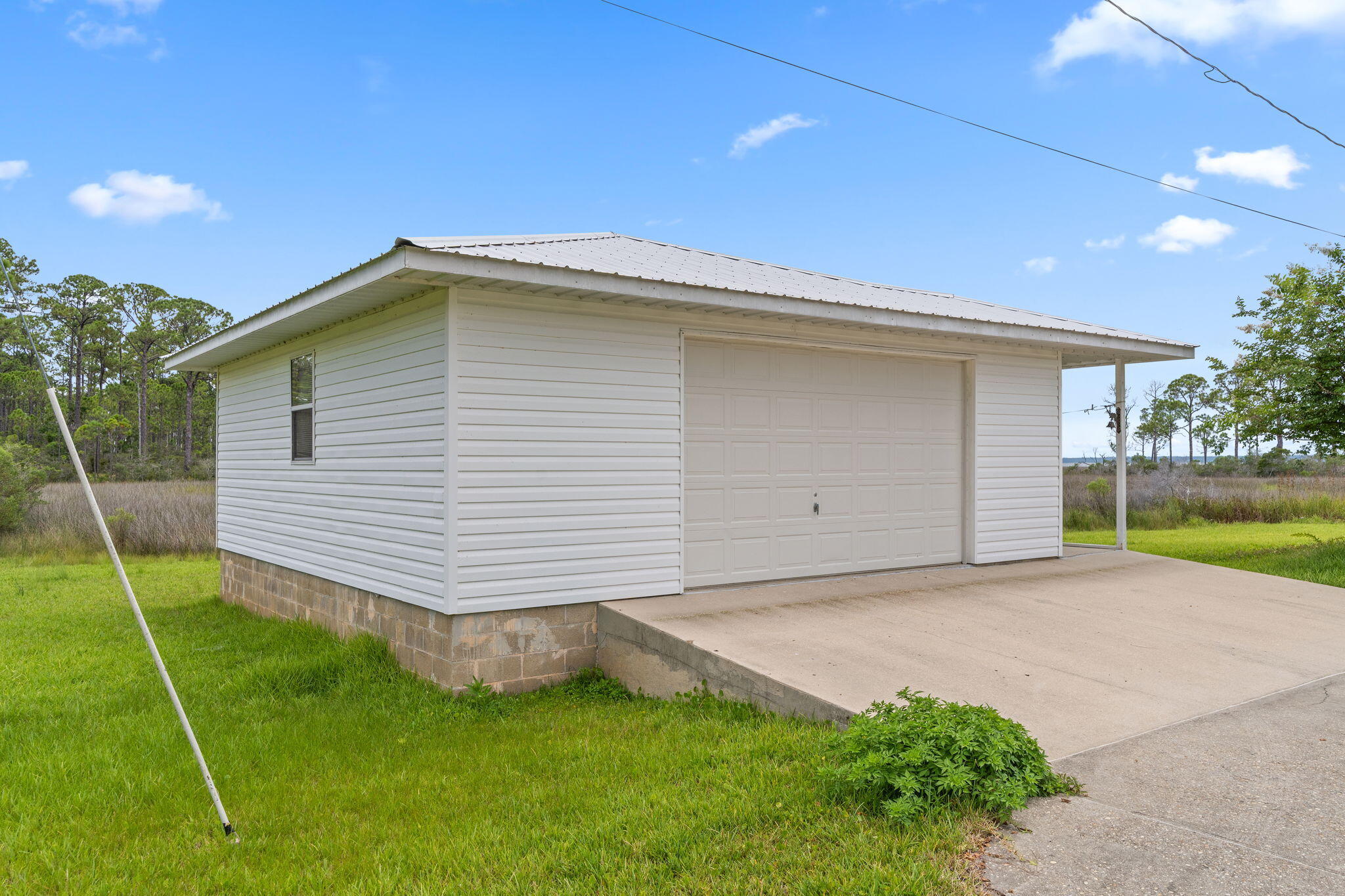 1357 Pearson Road Milton, FL 32583 - Photo 35 of 52 a front view of a house with a yard and garage