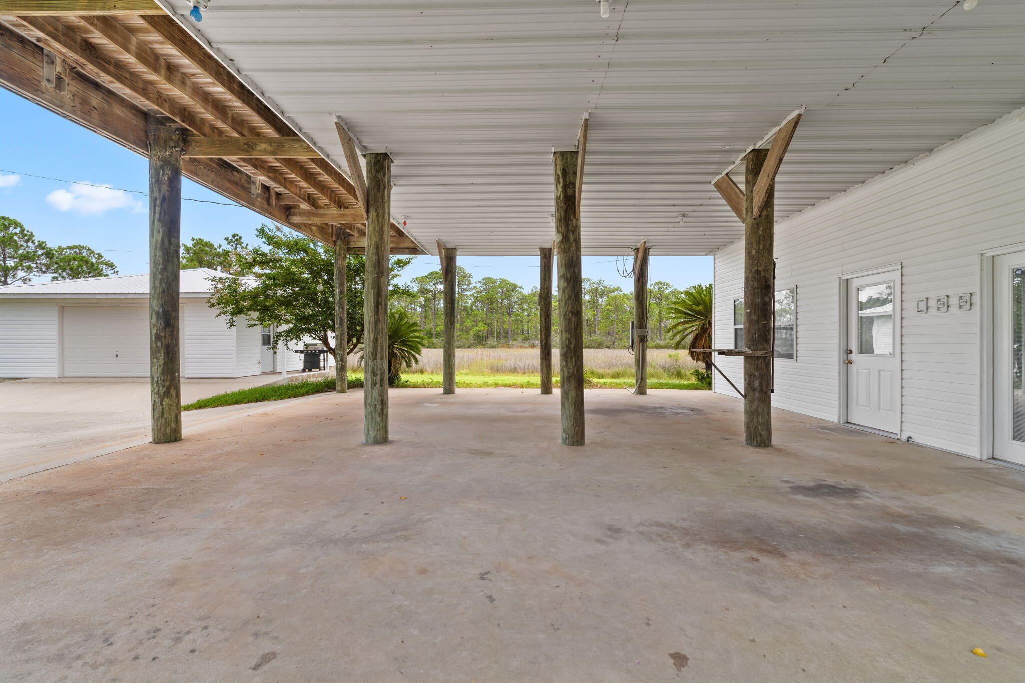 1357 Pearson Road Milton, FL 32583 - Photo 38 of 52 a view of an empty room with wooden floor and floor to ceiling windows