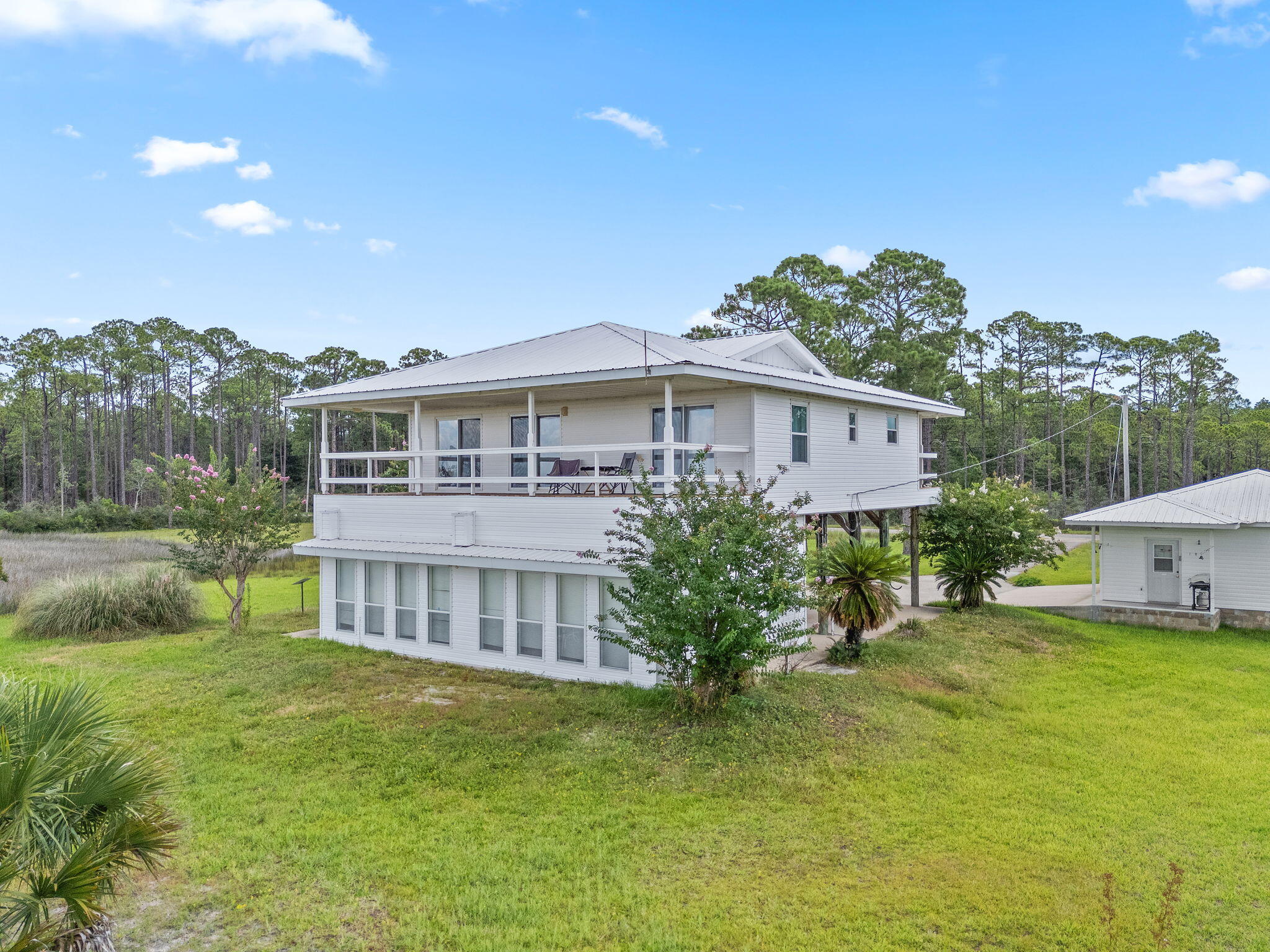 1357 Pearson Road Milton, FL 32583 - Photo 39 of 52 a view of a house with a big yard and potted plants