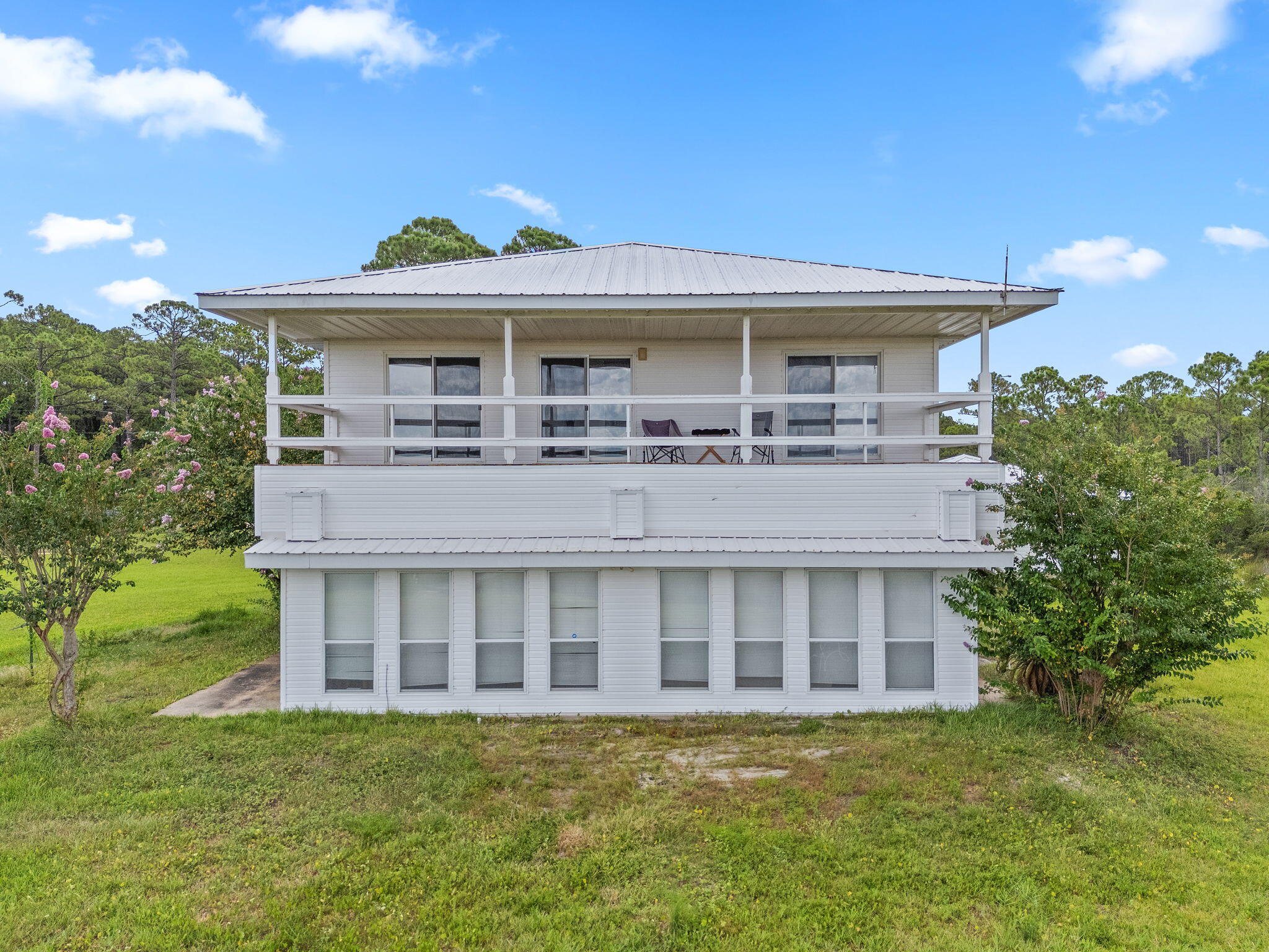 1357 Pearson Road Milton, FL 32583 - Photo 41 of 52 a view of a large building with a big yard and large trees