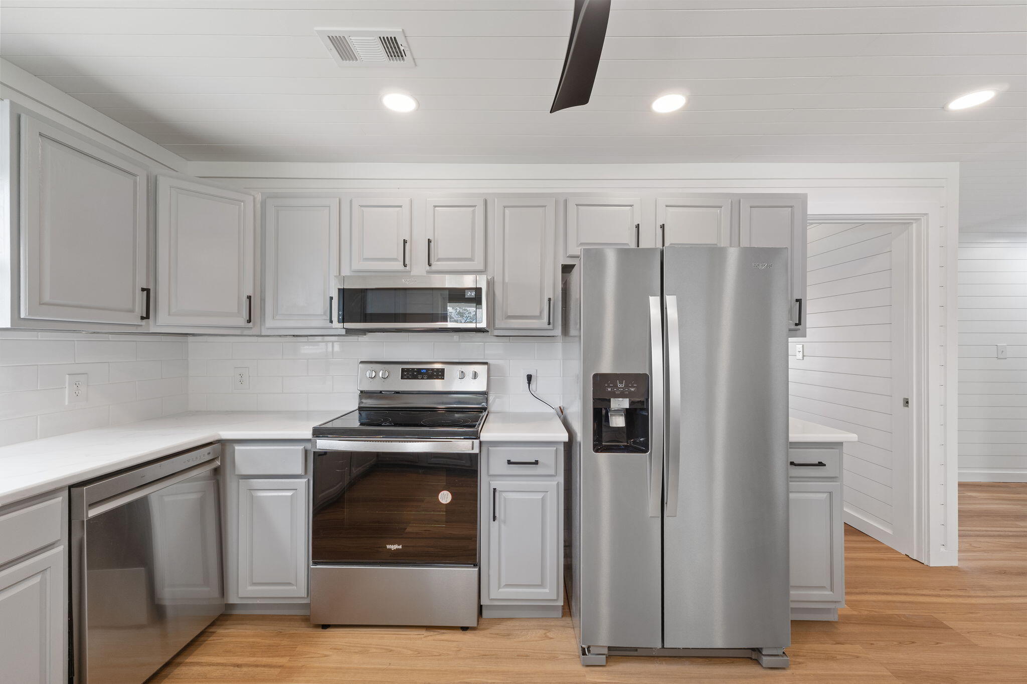 1357 Pearson Road Milton, FL 32583 - Photo 7 of 52 a kitchen with cabinets stainless steel appliances and wooden floor