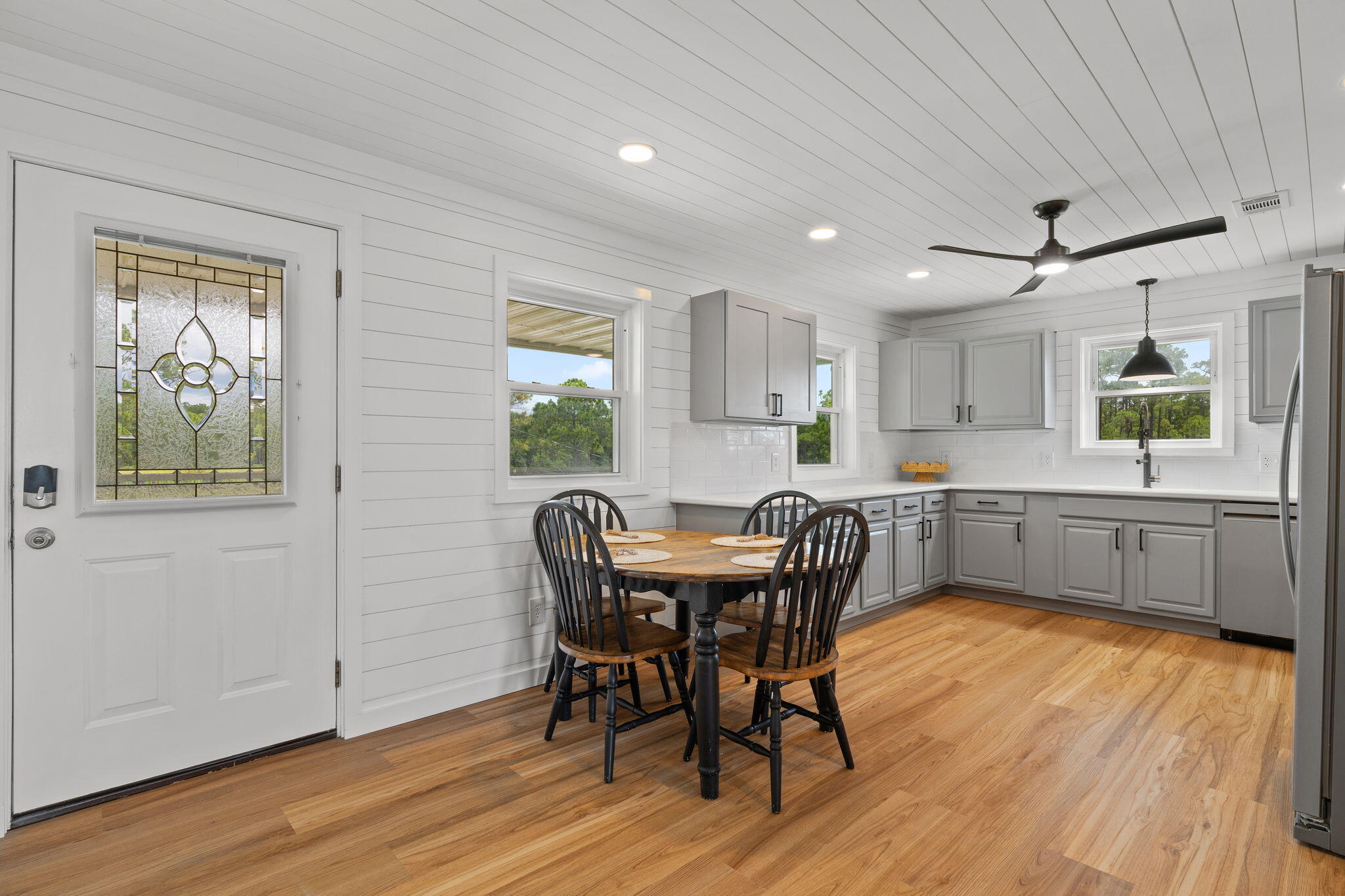 1357 Pearson Road Milton, FL 32583 - Photo 10 of 52 a view of a dining room with furniture and wooden floor