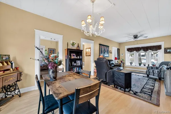 a view of a dining room with furniture and a chandelier