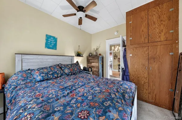 a bedroom with a large bed and a chandelier
