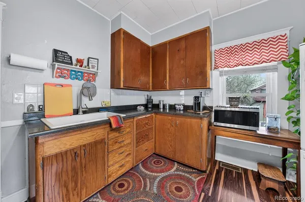 a kitchen with stainless steel appliances a stove a sink and a microwave