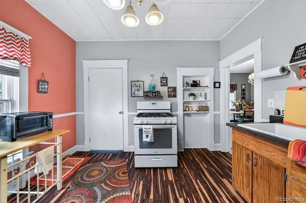 a kitchen with granite countertop stainless steel appliances and wooden cabinets