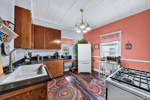 a kitchen with stainless steel appliances granite countertop a stove refrigerator sink and dishwasher
