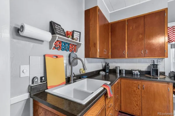 a kitchen with stainless steel appliances a sink a stove a refrigerator a counter top space and cabinets