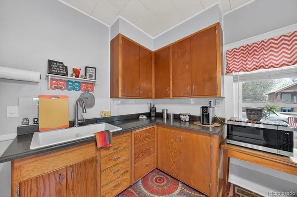 a kitchen with stainless steel appliances a sink a stove and a microwave