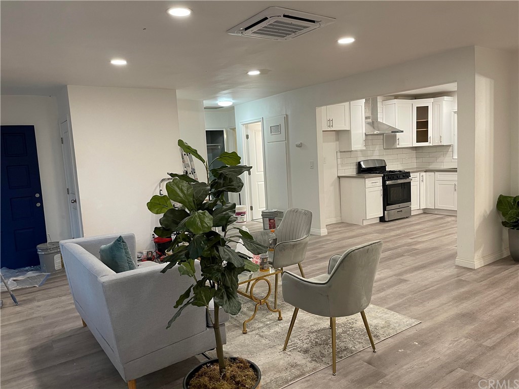 2781 Avalon Street Riverside, CA 92509 - Photo 1 of 1 a living room with furniture kitchen view and a potted plant