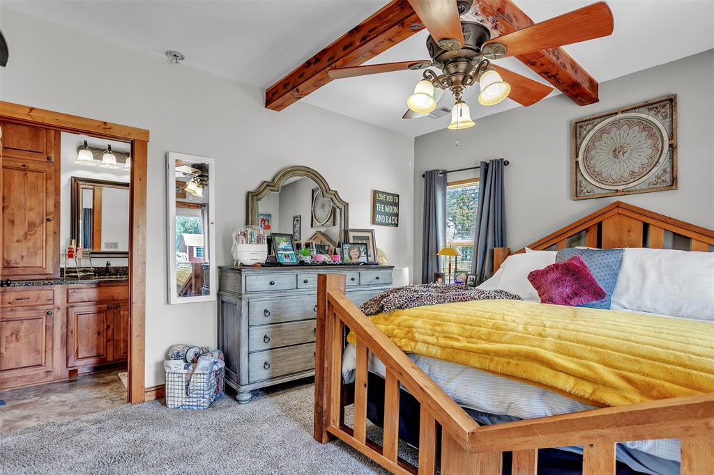 899 Fcr, Unit 930 Teague, TX 75860 - Photo 13 of 28 a bedroom with a bed a dresser and potted plants