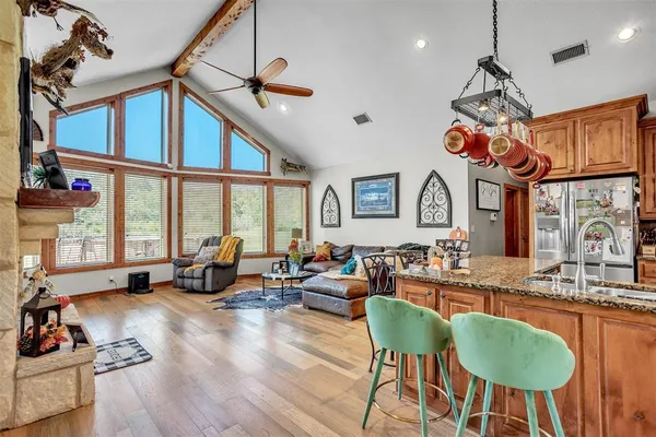a very nice looking living room with a large window and a chandelier