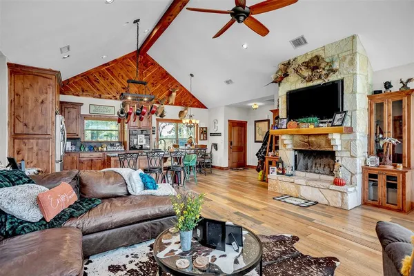 a living room with furniture a flat screen tv and a fireplace