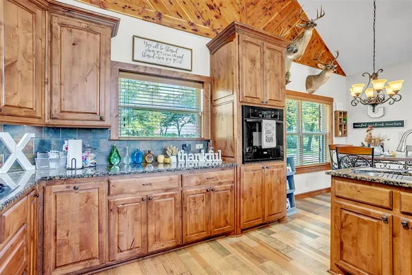 a kitchen with stainless steel appliances granite countertop a stove and cabinets