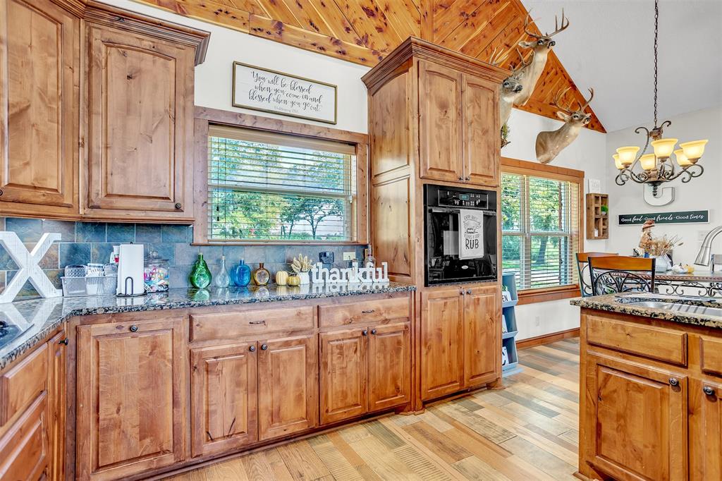 899 Fcr, Unit 930 Teague, TX 75860 - Photo 10 of 28 a kitchen with stainless steel appliances granite countertop a stove and cabinets