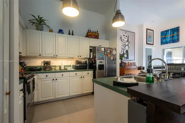 a kitchen with refrigerator and cabinets