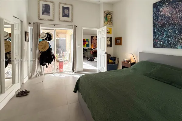 a bed room with a bed and a painting on the wall