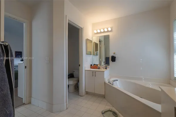 a bathroom with a bathtub a toilet and a shower