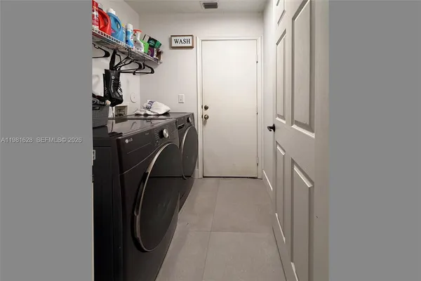 a view of storage and utility room with refrigerator