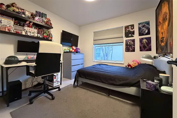 a bedroom with a bed and flat screen tv