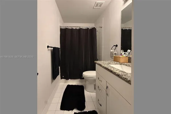 a kitchen with a sink and a refrigerator