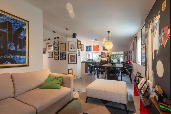 a living room with furniture a chandelier and a flat screen tv