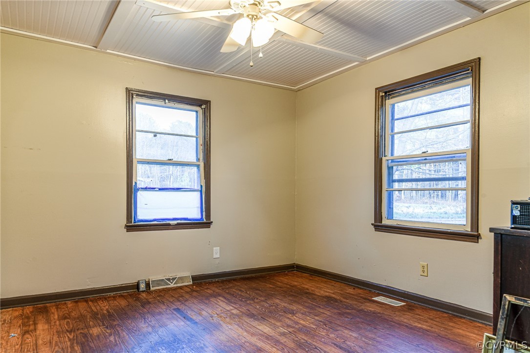 3071 Afton Grove Road Kenbridge, VA 23944 - Photo 5 of 30 a view of an empty room with wooden floor and a window