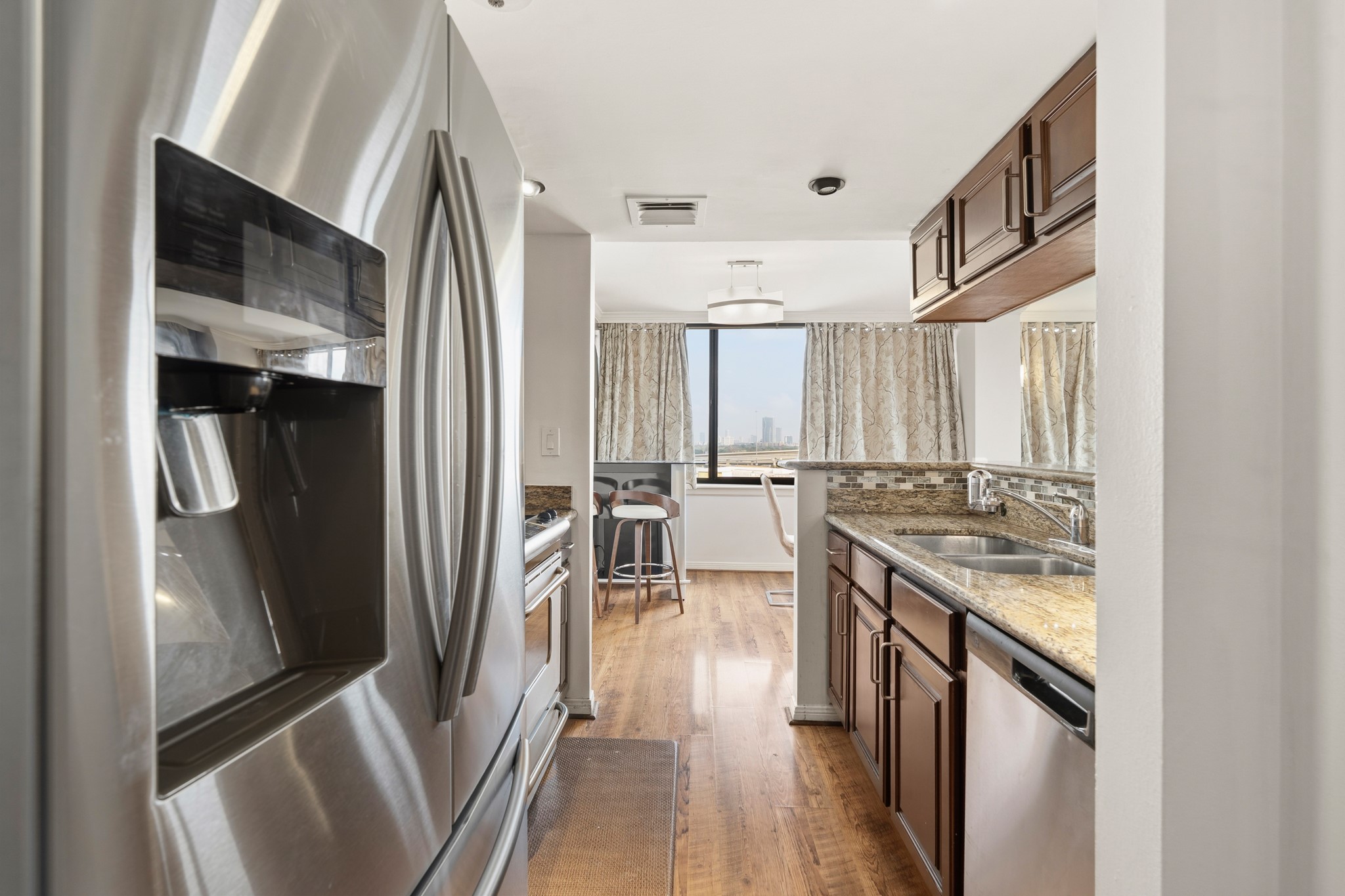3525 Sage Road, Unit 1204 Houston, TX 77056 - Photo 7 of 25 Galley-style with stainless steel refrigerator and ample cabinet storage.