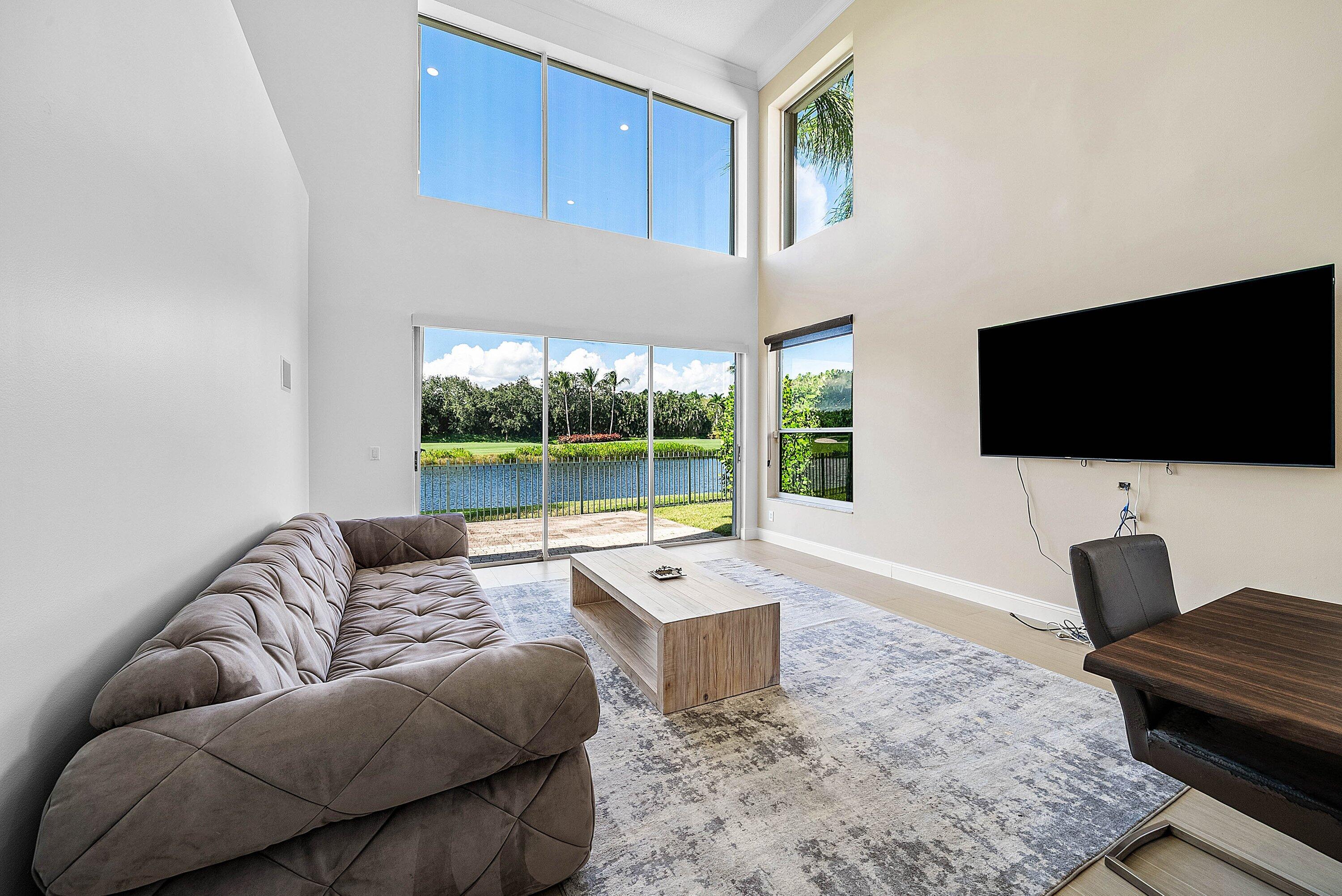 5855 Northwest 42nd Way Boca Raton, FL 33496 - Photo 12 of 77 a living room with furniture and a flat screen tv