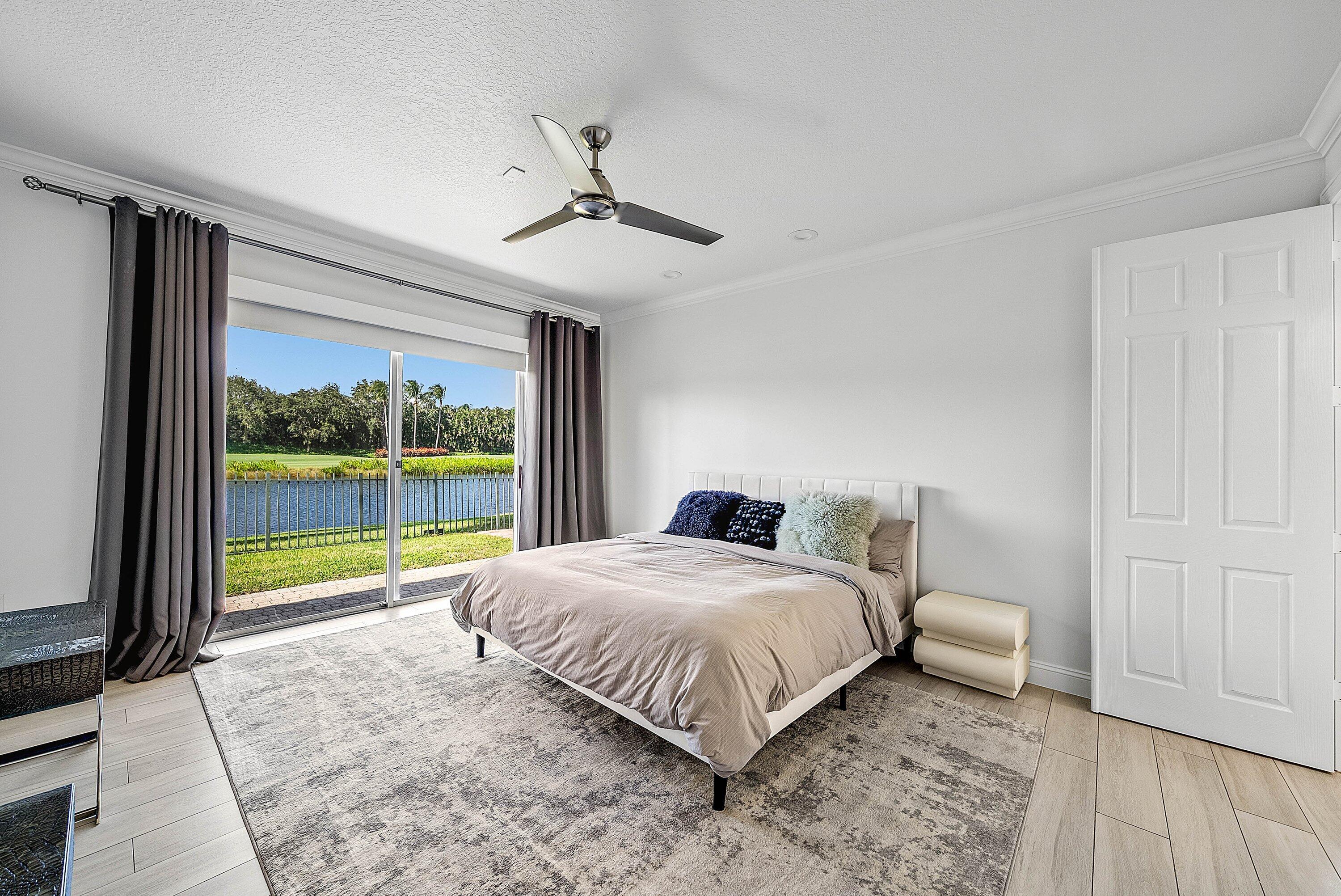 5855 Northwest 42nd Way Boca Raton, FL 33496 - Photo 19 of 77 a bedroom with a large bed and a large window