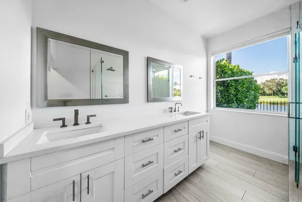 a en suite spacious bedroom with a bed and a large window