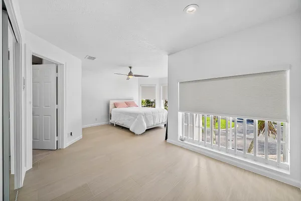 a bedroom with a bed and a painting on the wall