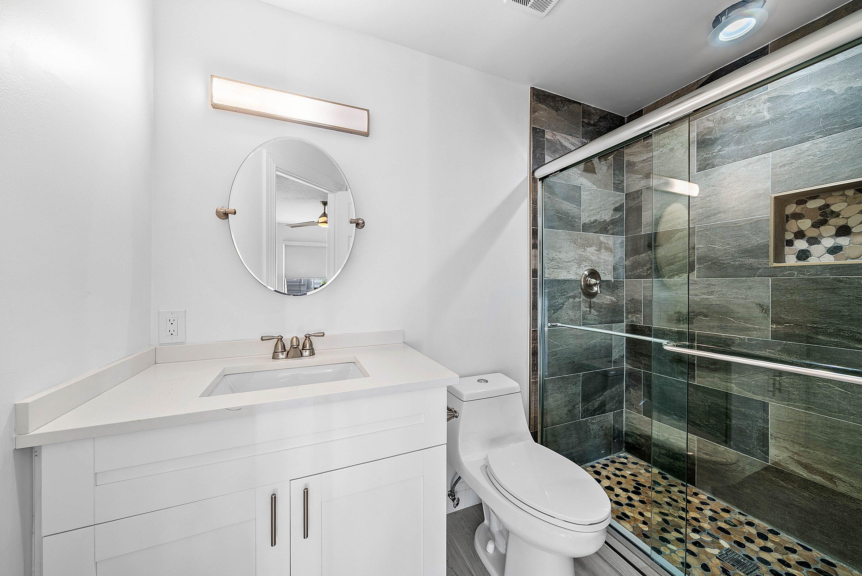 5855 Northwest 42nd Way Boca Raton, FL 33496 - Photo 29 of 77 a bathroom with a sink a toilet and shower